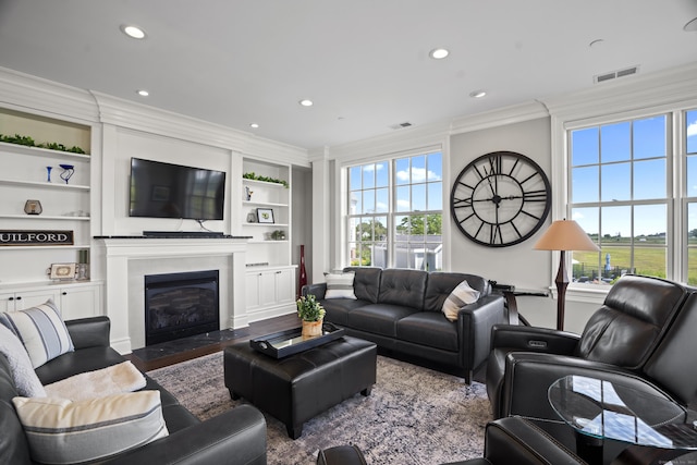 66 High St Unit 31, Guilford, CT 06437 - living room with crown molding, recessed lighting, plenty of natural light, a fireplace with flush hearth, and built in shelves