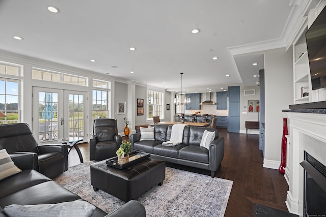 66 High St Unit 31, Guilford, CT 06437 - living area featuring ornamental molding, a fireplace with flush hearth, recessed lighting, plenty of natural light, and dark wood-type flooring
