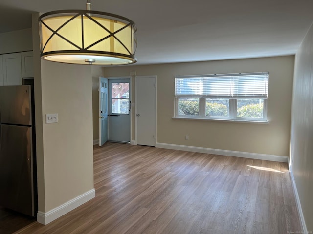 29 Van Buren Ave Unit J4, Norwalk, CT 06850 - unfurnished dining area featuring wood finished floors and baseboards
