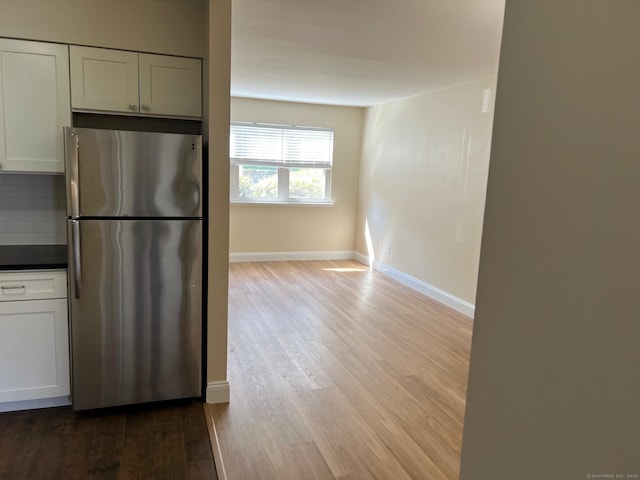 29 Van Buren Ave Unit J4, Norwalk, CT 06850 - kitchen featuring freestanding refrigerator, wood finished floors, backsplash, and white cabinets