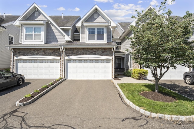 12 Sampson Ter Unit 12, Danbury, CT 06810 - view of front of home with asphalt driveway, an attached garage, and stone siding