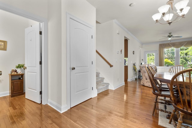 12 Sampson Ter Unit 12, Danbury, CT 06810 - dining room with light wood-style flooring, stairs, a chandelier, ornamental molding, and ceiling fan