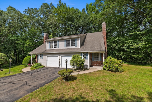 13 Waterview Dr, Windsor, CT 06095 - view of front facade with a chimney, asphalt driveway, a front yard, and an attached garage