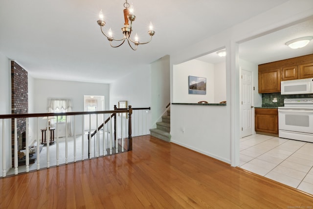 13 Waterview Dr, Windsor, CT 06095 - hall featuring a chandelier, light wood-style floors, and stairs