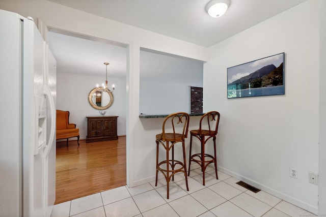 13 Waterview Dr, Windsor, CT 06095 - dining area with light tile patterned floors and a chandelier