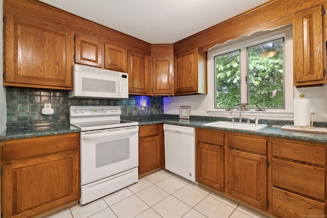 13 Waterview Dr, Windsor, CT 06095 - kitchen featuring white appliances, brown cabinets, dark countertops, and light tile patterned floors
