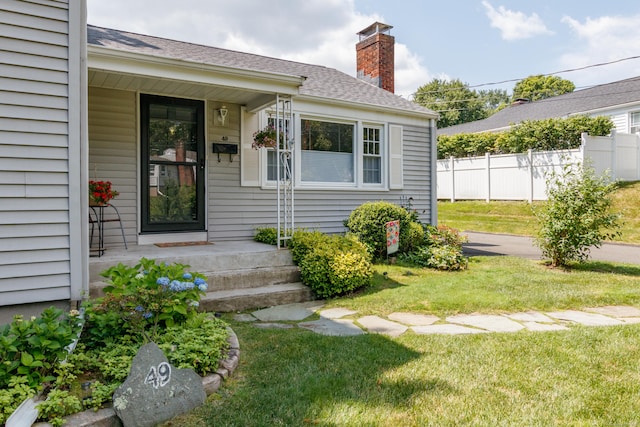 49 Remington Rd, Windsor, CT 06095 - view of exterior entry with a chimney and roof with shingles