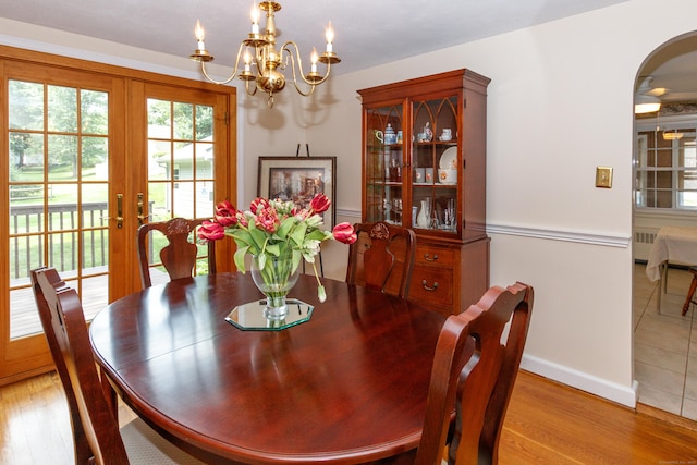 49 Remington Rd, Windsor, CT 06095 - dining space featuring french doors, wood finished floors, a chandelier, and radiator heating unit