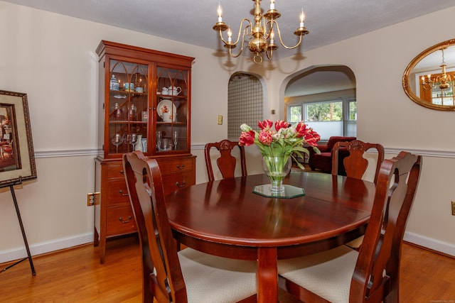 49 Remington Rd, Windsor, CT 06095 - dining space with a chandelier, light wood-type flooring, and arched walkways