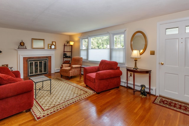 49 Remington Rd, Windsor, CT 06095 - living room featuring a baseboard heating unit, wood finished floors, and a fireplace