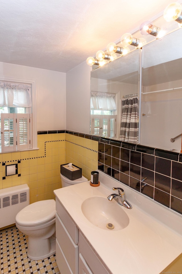 49 Remington Rd, Windsor, CT 06095 - bathroom featuring radiator heating unit, tile walls, vanity, a shower with shower curtain, and wainscoting