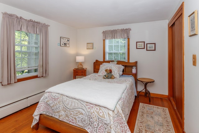 49 Remington Rd, Windsor, CT 06095 - bedroom featuring a baseboard heating unit, wood finished floors, and a closet