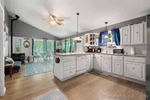 27 Laurelwood Dr, East Lyme, CT 06357 - kitchen featuring dishwasher, light wood-style flooring, lofted ceiling, ceiling fan, and a peninsula