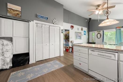 27 Laurelwood Dr, East Lyme, CT 06357 - kitchen with dishwasher, a ceiling fan, wood finished floors, white cabinets, and pendant lighting