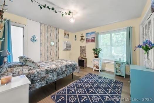 27 Laurelwood Dr, East Lyme, CT 06357 - bedroom with wood finished floors and a wall unit AC