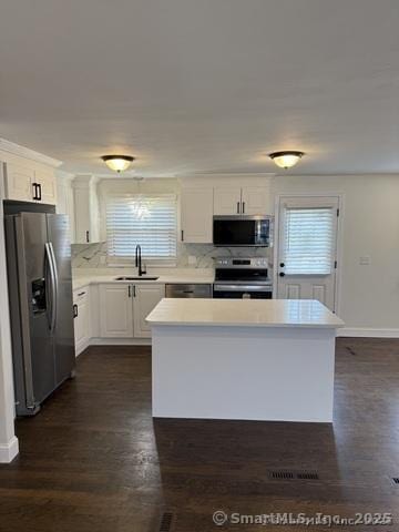 90 Diane Dr, South Windsor, CT 06074 - kitchen with stainless steel appliances, dark wood-type flooring, white cabinets, and light countertops