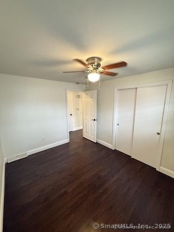 90 Diane Dr, South Windsor, CT 06074 - unfurnished bedroom with dark wood-style floors, a closet, and a ceiling fan