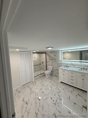 90 Diane Dr, South Windsor, CT 06074 - bathroom with a marble finish shower, double vanity, and marble finish floors