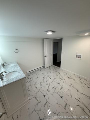 90 Diane Dr, South Windsor, CT 06074 - bathroom featuring baseboard heating, marble finish floors, and double vanity