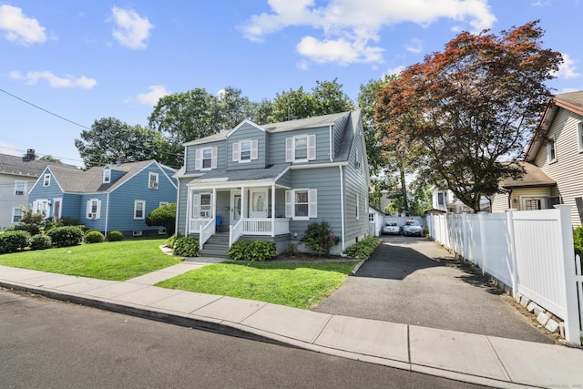 19 Plymouth Ave, Norwalk, CT 06851 - traditional-style home featuring covered porch, asphalt driveway, and a shingled roof