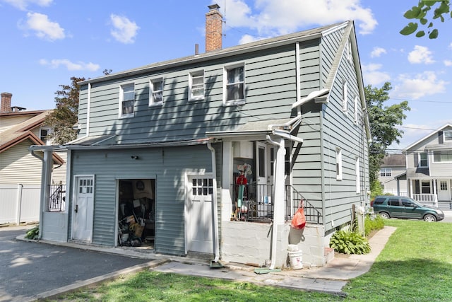 19 Plymouth Ave, Norwalk, CT 06851 - rear view of property featuring a chimney and a lawn