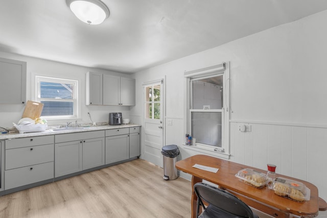 19 Plymouth Ave, Norwalk, CT 06851 - kitchen with gray cabinetry, light wood-style flooring, healthy amount of natural light, light countertops, and wainscoting