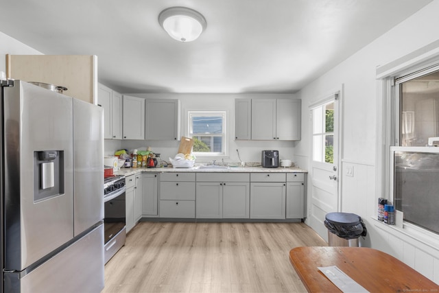 19 Plymouth Ave, Norwalk, CT 06851 - kitchen featuring appliances with stainless steel finishes, gray cabinetry, and light wood-type flooring