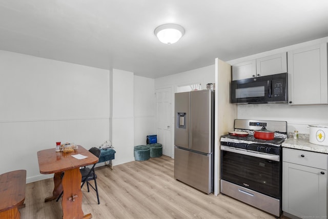 19 Plymouth Ave, Norwalk, CT 06851 - kitchen featuring appliances with stainless steel finishes, light wood-style flooring, and light stone counters