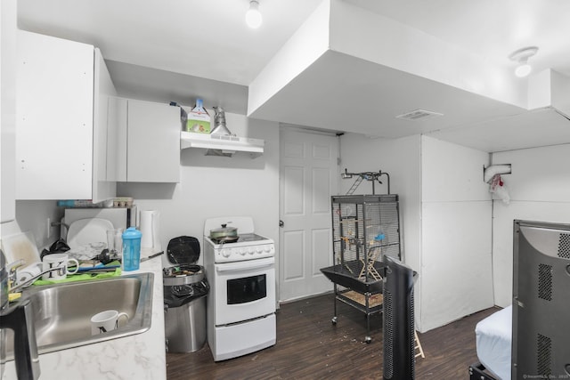 19 Plymouth Ave, Norwalk, CT 06851 - kitchen with electric stove, dark wood-style flooring, under cabinet range hood, white cabinetry, and light countertops