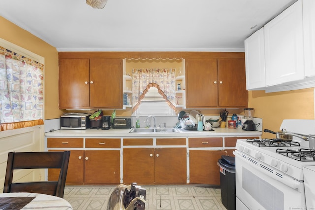 19 Plymouth Ave, Norwalk, CT 06851 - kitchen with white gas range oven, light countertops, brown cabinetry, and light flooring