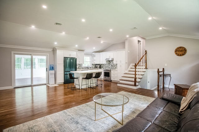 7 Derenthal Dr, Madison, CT 06443 - living area with vaulted ceiling, crown molding, dark wood-type flooring, stairs, and recessed lighting