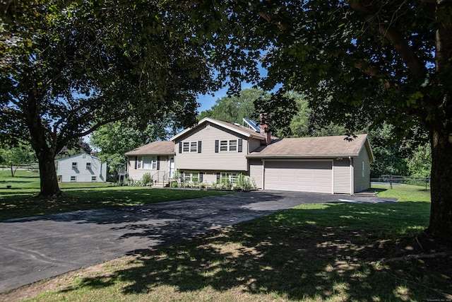 7 Derenthal Dr, Madison, CT 06443 - tri-level home featuring driveway, a chimney, and an attached garage