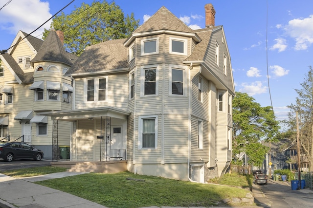 78 Pine St, Waterbury, CT 06710 - victorian home with a front yard, a chimney, and a shingled roof