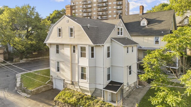 78 Pine St, Waterbury, CT 06710 - back of house with roof with shingles, a garage, and asphalt driveway