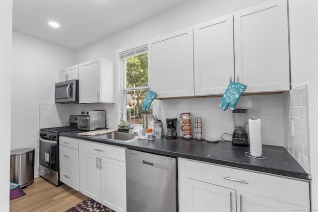 78 Pine St, Waterbury, CT 06710 - kitchen featuring stainless steel appliances, dark countertops, white cabinetry, and recessed lighting