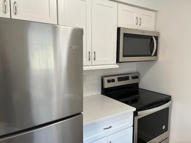 29 Van Buren Ave Unit H7, Norwalk, CT 06850 - kitchen featuring stainless steel appliances, decorative backsplash, white cabinetry, and light countertops