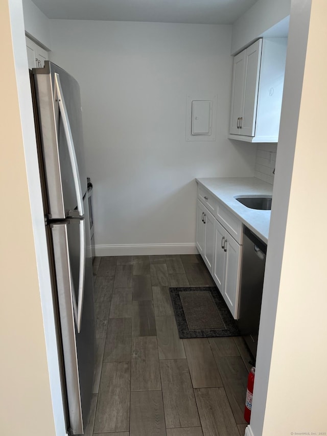 29 Van Buren Ave Unit H7, Norwalk, CT 06850 - kitchen with appliances with stainless steel finishes, white cabinets, and dark wood-style floors