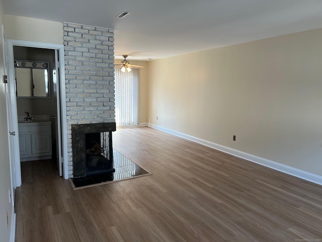 29 Van Buren Ave Unit H7, Norwalk, CT 06850 - unfurnished living room with wood finished floors, a fireplace, and ceiling fan