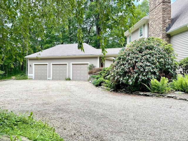 67 Transylvania Rd, Roxbury, CT 06783 - view of home's exterior featuring an attached garage, gravel driveway, and a chimney