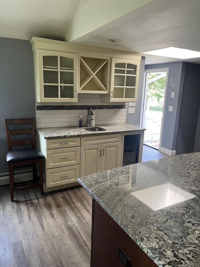 81 Cornwall Dr, Windsor Locks, CT 06096 - kitchen with dark wood finished floors, decorative backsplash, light stone countertops, and glass insert cabinets