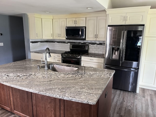 81 Cornwall Dr, Windsor Locks, CT 06096 - kitchen with stainless steel refrigerator with ice dispenser, range with gas cooktop, cream cabinetry, wood finished floors, and dark stone countertops