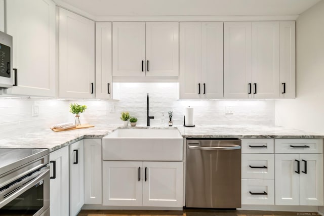 12 Boulevard Dr Unit 27-157, Danbury, CT 06810 - kitchen featuring stainless steel appliances, white cabinetry, decorative backsplash, and light stone countertops
