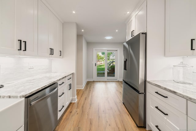 12 Boulevard Dr Unit 27-157, Danbury, CT 06810 - kitchen with stainless steel appliances, light wood-style flooring, white cabinetry, tasteful backsplash, and recessed lighting