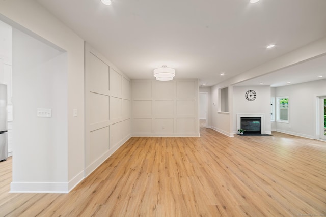 12 Boulevard Dr Unit 27-157, Danbury, CT 06810 - unfurnished living room featuring light wood-type flooring, recessed lighting, and a glass covered fireplace