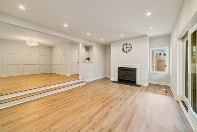 12 Boulevard Dr Unit 27-157, Danbury, CT 06810 - unfurnished living room with wood finished floors, a fireplace with flush hearth, and recessed lighting