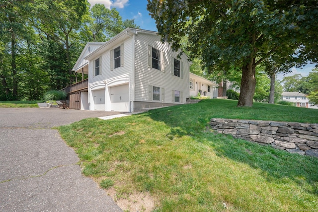 117 Woodfield Rd, Bristol, CT 06010 - view of home's exterior with a garage, asphalt driveway, and a lawn