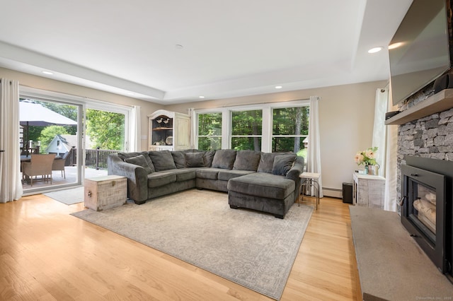 117 Woodfield Rd, Bristol, CT 06010 - living room featuring plenty of natural light, a raised ceiling, a stone fireplace, light wood-style floors, and recessed lighting