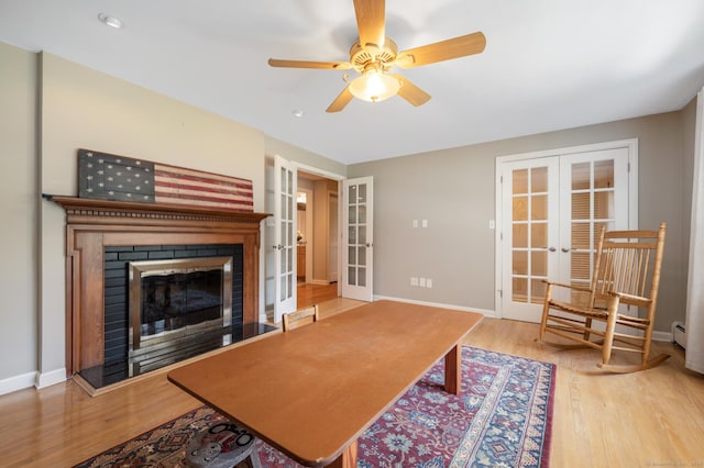 117 Woodfield Rd, Bristol, CT 06010 - living area featuring french doors, wood finished floors, a ceiling fan, and a glass covered fireplace