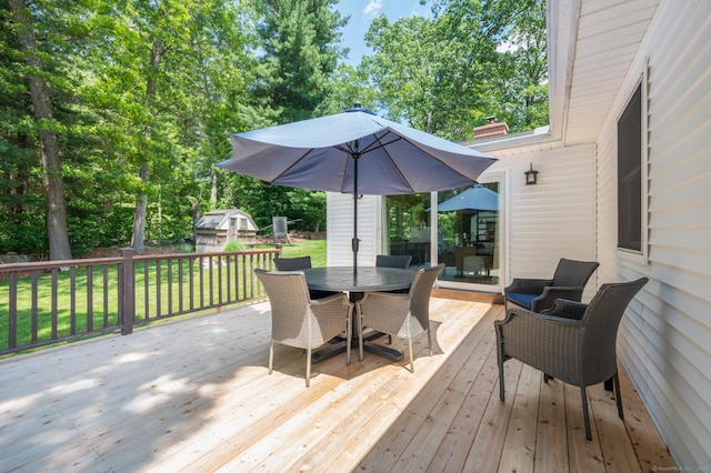 117 Woodfield Rd, Bristol, CT 06010 - wooden deck with outdoor dining space, a yard, and view of wooded area