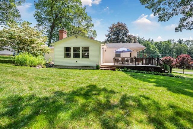 117 Woodfield Rd, Bristol, CT 06010 - back of property featuring a deck, a chimney, and a lawn